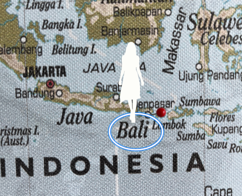 Silhouette of woman on the map near Bali.